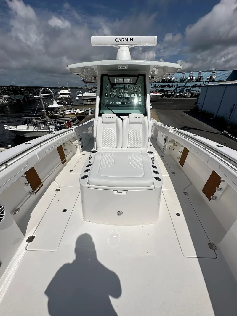 Slide: The Image of 2025 Caymas 34 CT boat with Garmin navigation, docked at a marina. - 8