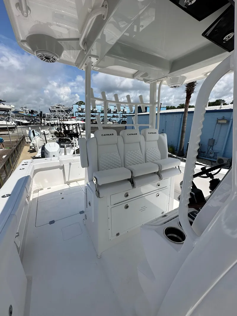 Slide: The Image of 2025 Caymas 34 CT boat interior with white seating and helm station. - 9