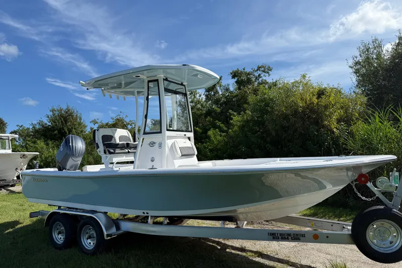 The Image of 2026 Tidewater 2210 Carolina Bay boat on trailer, parked outdoors under blue sky. - 0
