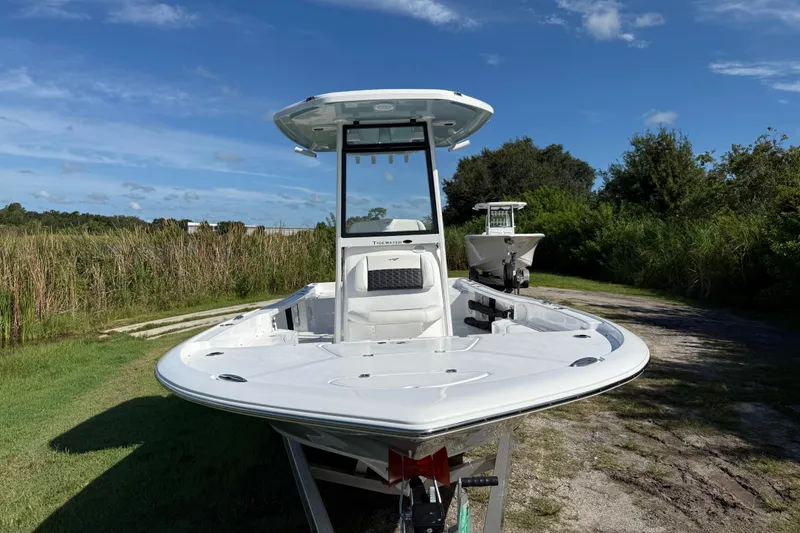 Slide: The Image of 2026 Tidewater 2210 Carolina Bay boat on grassy path under blue sky. - 11