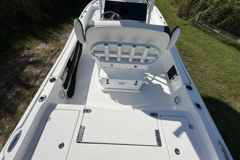 Slide: The Image of 2026 Tidewater 2210 Carolina Bay boat interior with rod holders and storage compartments. - 12