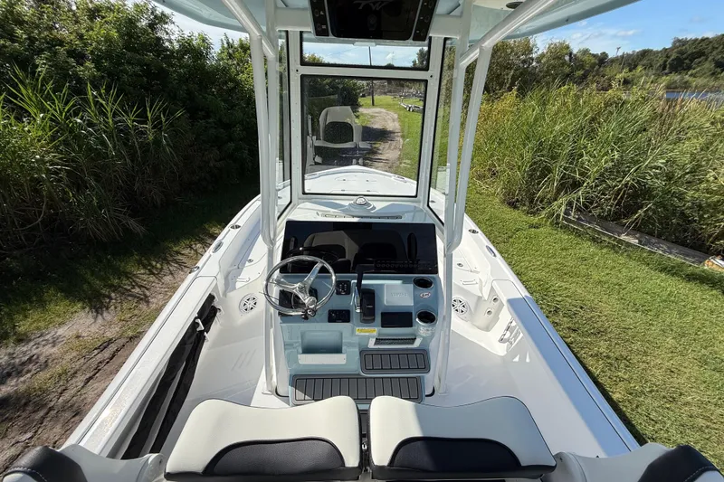 Slide: The Image of 2026 Tidewater 2210 Carolina Bay boat interior with steering console and seating. - 14