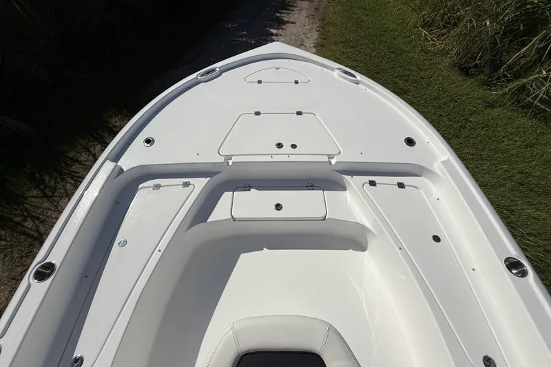 Slide: The Image of 2026 Tidewater 2210 Carolina Bay boat deck with storage compartments and sleek design. - 17