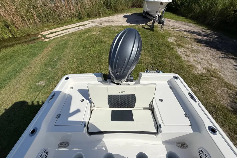 Slide: The Image of 2026 Tidewater 2210 Carolina Bay boat with outboard motor on grassy area. - 24
