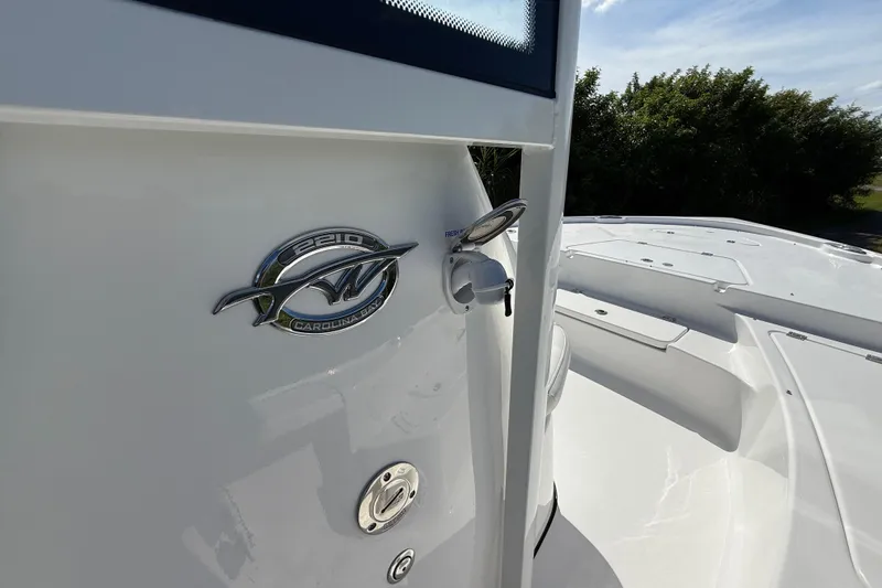 Slide: The Image of 2026 Tidewater 2210 Carolina Bay boat, sleek design with emblem and deck view. - 37