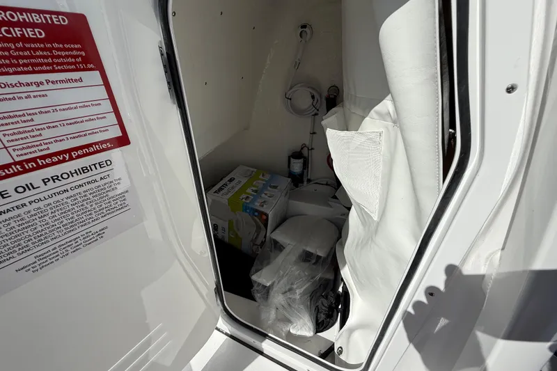 Slide: The Image of Interior storage of 2026 Tidewater 2210 Carolina Bay boat with safety instructions. - 39
