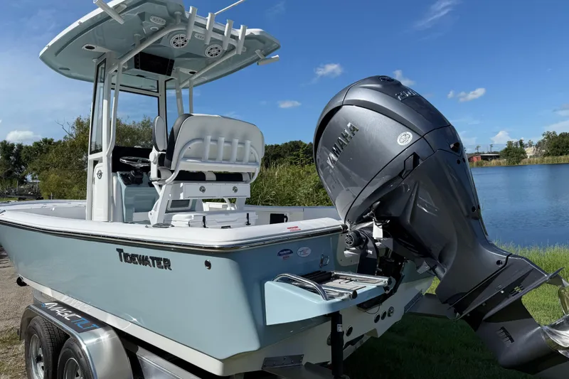 Slide: The Image of 2026 Tidewater 2210 Carolina Bay boat with Yamaha engine by a lake. - 4
