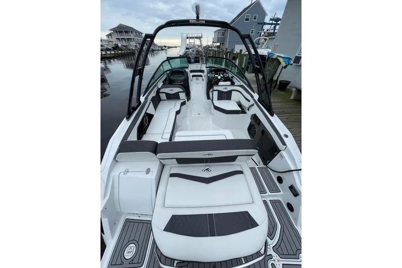 Slide: The Image of 2018 Monterey 258 Super Sport boat docked at a marina with cover on. - 2