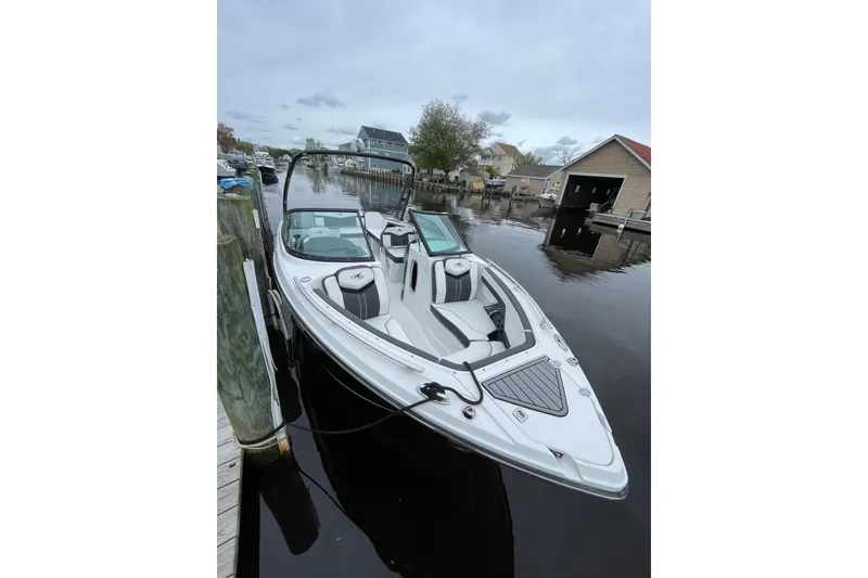 Slide: The Image of 2018 Monterey 258 Super Sport boat with sleek interior design docked at a marina. - 4