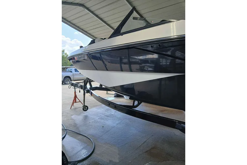 Slide: The Image of 2023 Heyday H22 boat under a covered area, side view. - 4