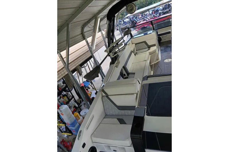 Slide: The Image of 2023 Heyday H22 boat interior with modern seating and steering wheel under a canopy. - 9