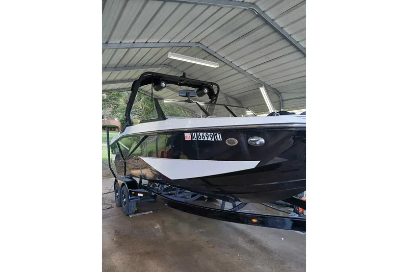 The Image of 2023 Heyday H22 boat under a metal canopy, black and white design. - 0