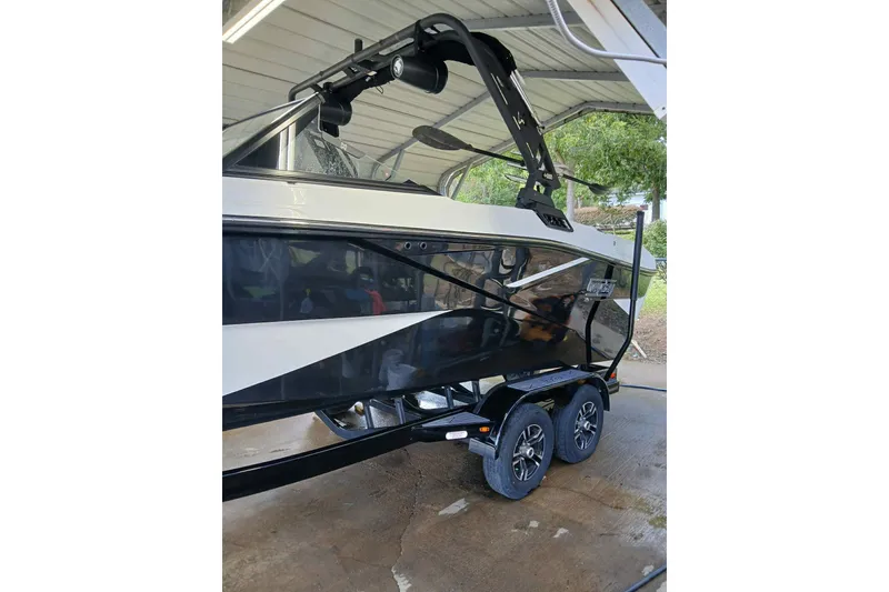 Slide: The Image of 2023 Heyday H22 boat on trailer under shelter, side view. - 2