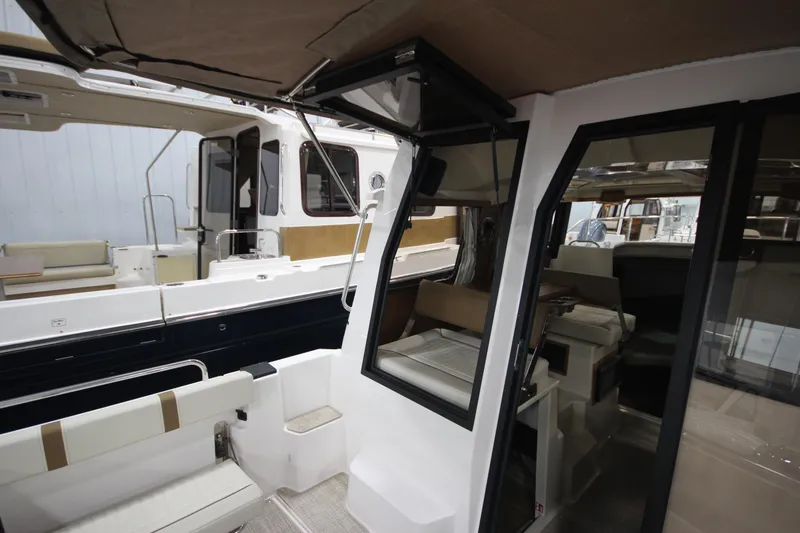 Slide: The Image of 2026 Ranger Tugs R-25 interior view, showcasing seating and cabin design. - 10