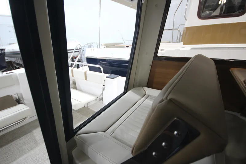 Slide: The Image of Interior view of 2026 Ranger Tugs R-25 boat, featuring comfortable seating and modern design. - 11