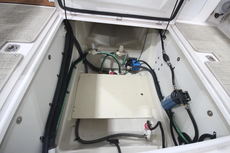 Slide: The Image of 2026 Ranger Tugs R-25 engine compartment with visible wiring and components. - 14