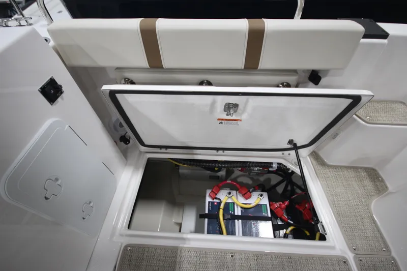 Slide: The Image of 2026 Ranger Tugs R-25 boat storage compartment with battery and wiring. - 15