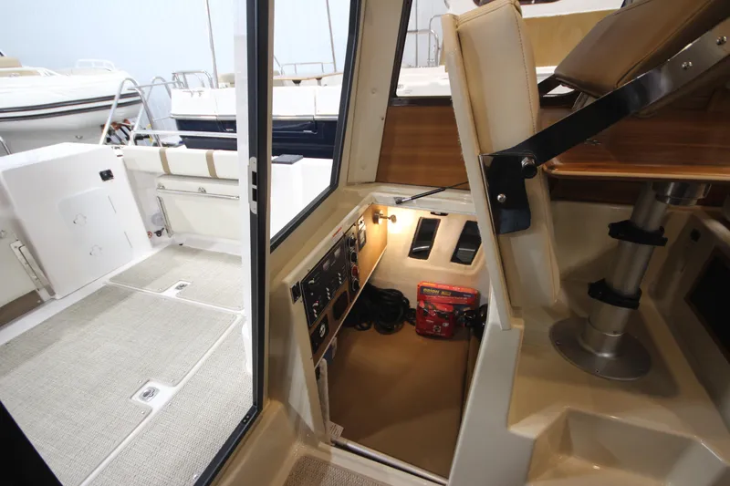 Slide: The Image of 2026 Ranger Tugs R-25 interior view, showcasing helm station and cockpit area. - 24