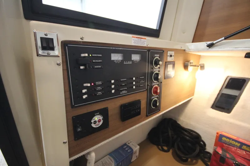 Slide: The Image of Control panel of 2026 Ranger Tugs R-25 boat with switches and dials. - 26