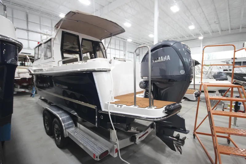 Slide: The Image of 2026 Ranger Tugs R-25 boat with Yamaha engine in indoor showroom. - 3
