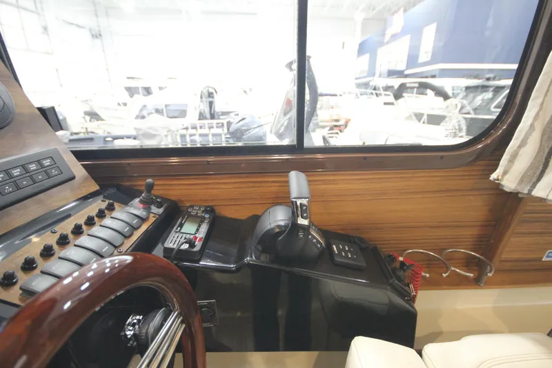 Slide: The Image of Interior helm of 2026 Ranger Tugs R-25, featuring control panel and steering wheel. - 32