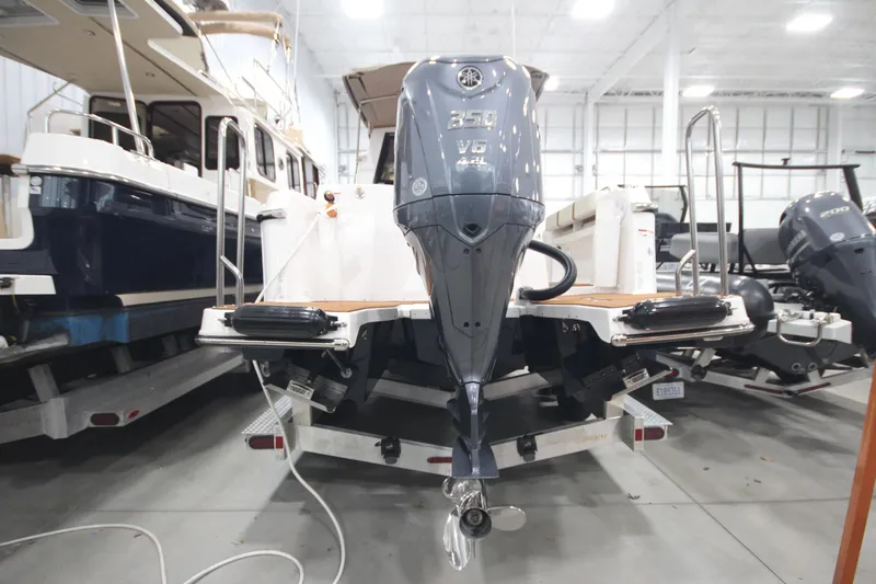 Slide: The Image of 2026 Ranger Tugs R-25 boat with Yamaha 350 V8 outboard engine in showroom. - 4