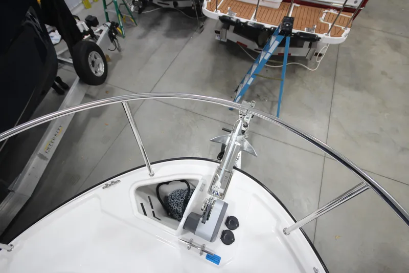 Slide: The Image of 2026 Ranger Tugs R-25 boat bow with anchor, in a garage setting. - 42