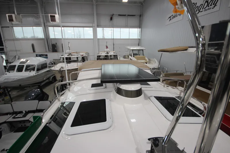 Slide: The Image of 2026 Ranger Tugs R-25 boat interior with solar panel, displayed in a showroom. - 44