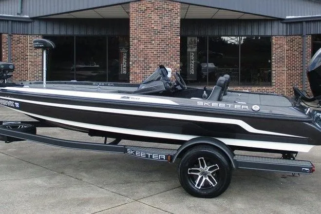 The Image of 2020 Skeeter ZX150 boat with sleek design parked outside a brick building. - 1