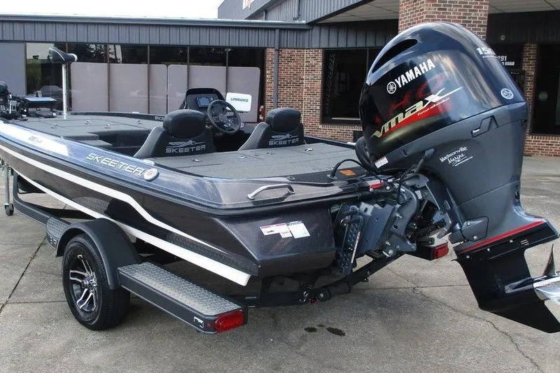 Slide: The Image of 2020 Skeeter ZX150 boat with Yamaha VMAX engine, parked outside a building. - 2
