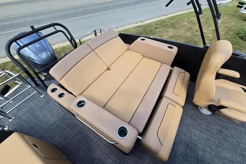 Slide: The Image of 2025 Godfrey Monaco 235 DFL boat interior with tan seating and cup holders. - 11