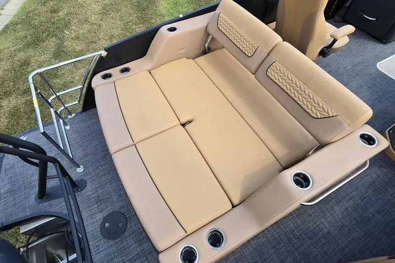 Slide: The Image of 2025 Godfrey Monaco 235 DFL iMPACT boat interior with tan seating and cup holders. - 13