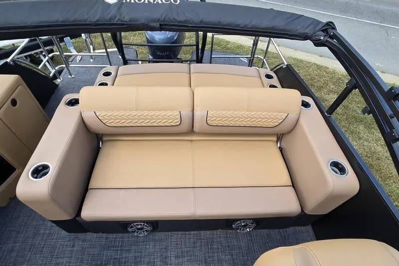 Slide: The Image of Luxurious seating on 2025 Godfrey Monaco 235 DFL iMPACT pontoon boat, featuring cup holders and stylish design. - 6