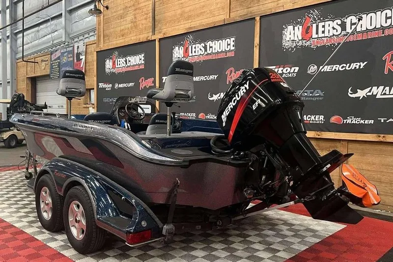 Slide: The Image of 2001 Ranger 619 SVS/DVS boat with Mercury engine displayed indoors. - 3