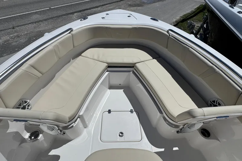 Slide: The Image of 2026 Robalo R232 Explorer boat interior with beige cushioned seating. - 10