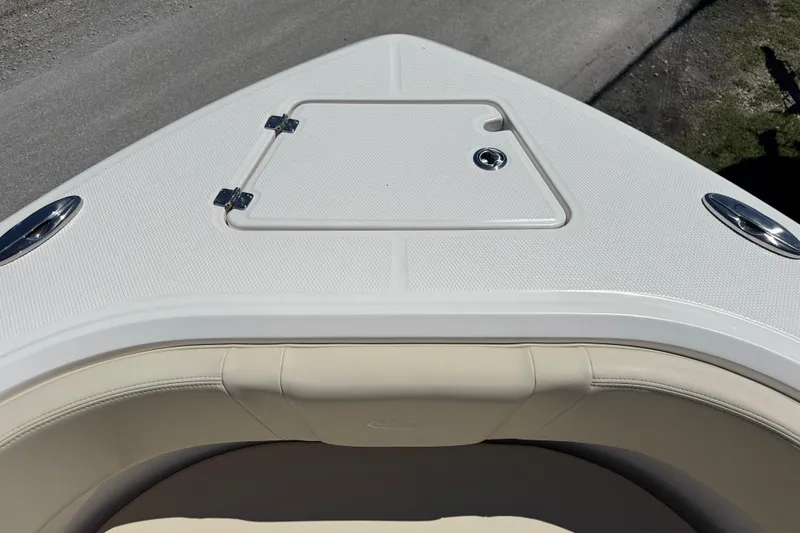 Slide: The Image of 2026 Robalo R232 Explorer boat bow with storage hatch and seating. - 11