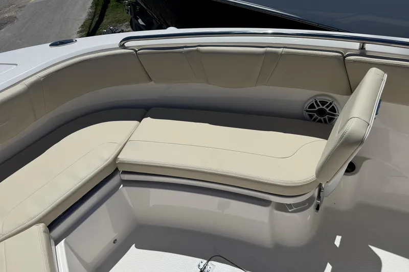 Slide: The Image of 2026 Robalo R232 Explorer boat with beige cushioned seating in the bow area. - 16