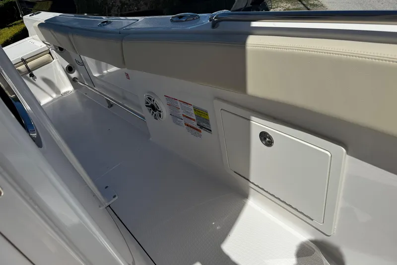 Slide: The Image of 2026 Robalo R232 Explorer boat interior with cushioned seating and storage compartment. - 17