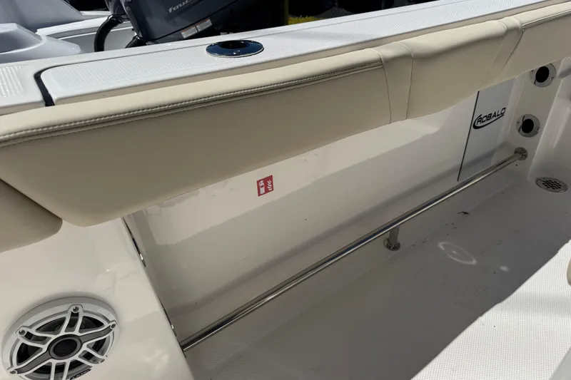Slide: The Image of 2026 Robalo R232 Explorer boat interior with cushioned seating and speaker. - 19