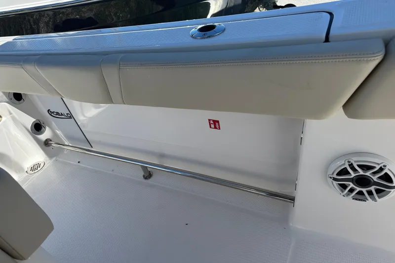 Slide: The Image of 2026 Robalo R232 Explorer boat interior with cushioned seating and speaker. - 20