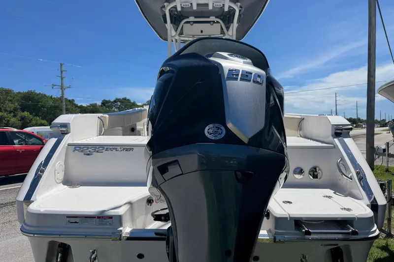 Slide: The Image of 2026 Robalo R232 Explorer boat with powerful outboard motor, parked under clear blue sky. - 3