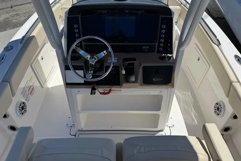 Slide: The Image of 2026 Robalo R232 Explorer boat cockpit with modern steering and control panel. - 7