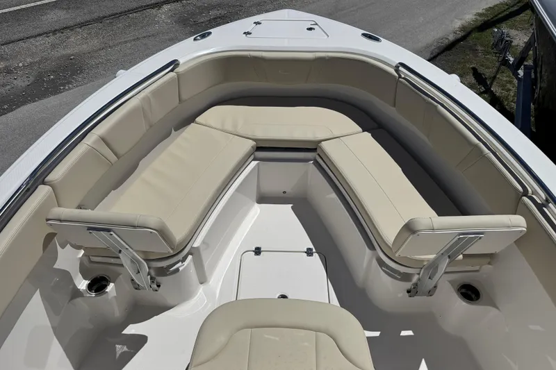 Slide: The Image of 2026 Robalo R232 Explorer boat interior with beige seating and stainless steel fixtures. - 9