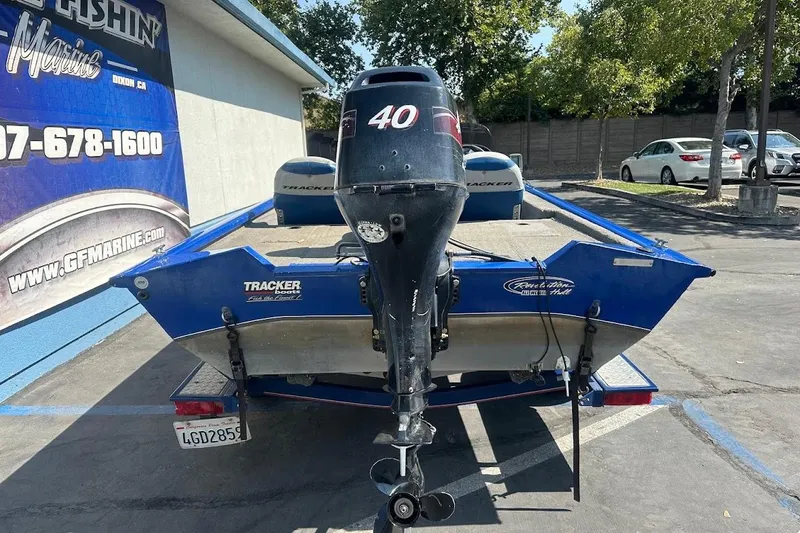 Slide: The Image of 2005 Bass Tracker Pro Team 175 boat with outboard motor in parking lot. - 10