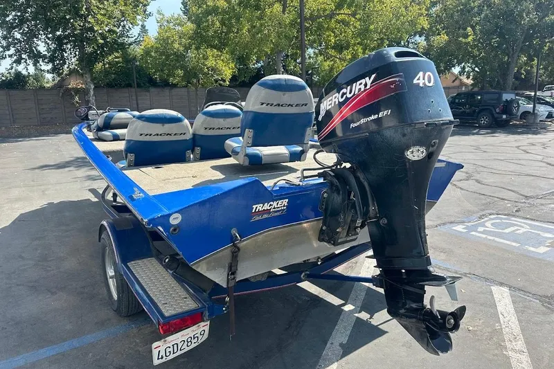 Slide: The Image of 2005 Bass Tracker Pro Team 175 boat with Mercury 40 outboard motor in parking lot. - 11