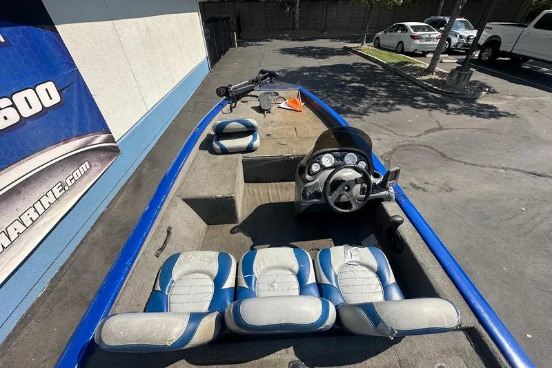 Slide: The Image of 2005 Bass Tracker Pro Team 175 boat interior with blue and gray seating and steering console. - 13
