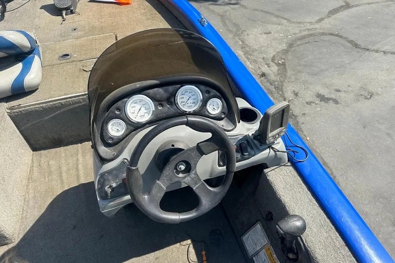 Slide: The Image of 2005 Bass Tracker Pro Team 175 boat dashboard with steering wheel and gauges. - 14
