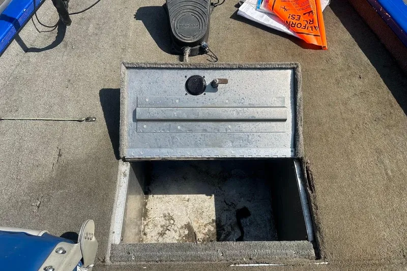 Slide: The Image of Open storage compartment on a 2005 Bass Tracker Pro Team 175 boat deck. - 22