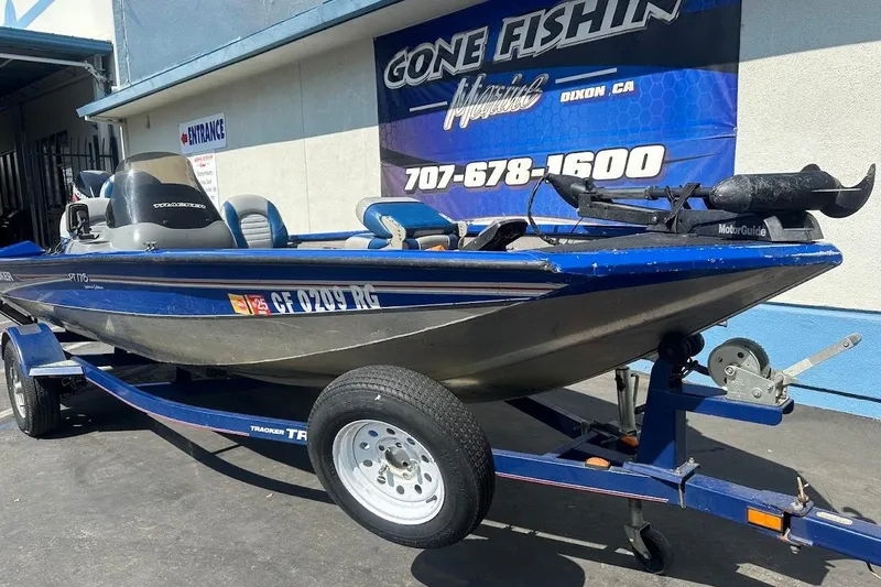 Slide: The Image of 2005 Bass Tracker Pro Team 175 boat on trailer, parked outside a marine shop. - 6