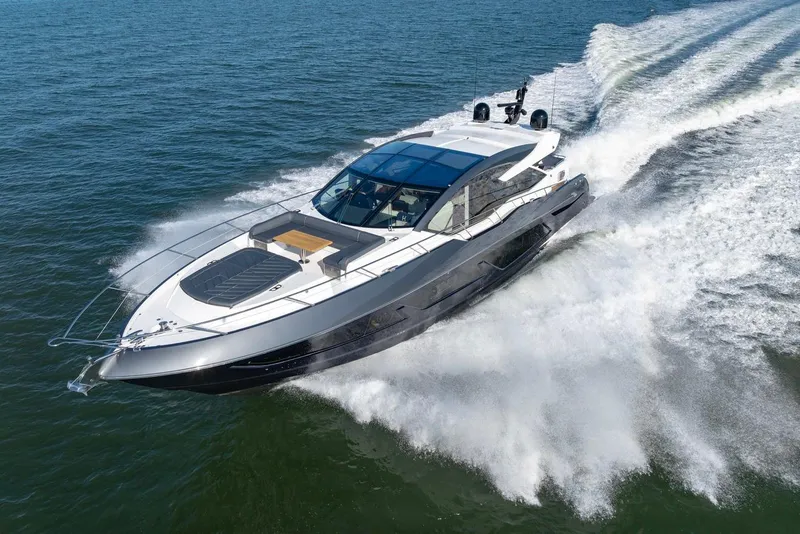 Slide: The Image of 2020 Sunseeker Predator 74 yacht cruising on open water, showcasing sleek design and luxury. - 14